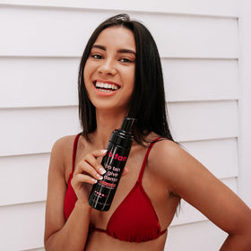 B.TAN bottle in a beach bag conveying travel-ready bronze maintenance