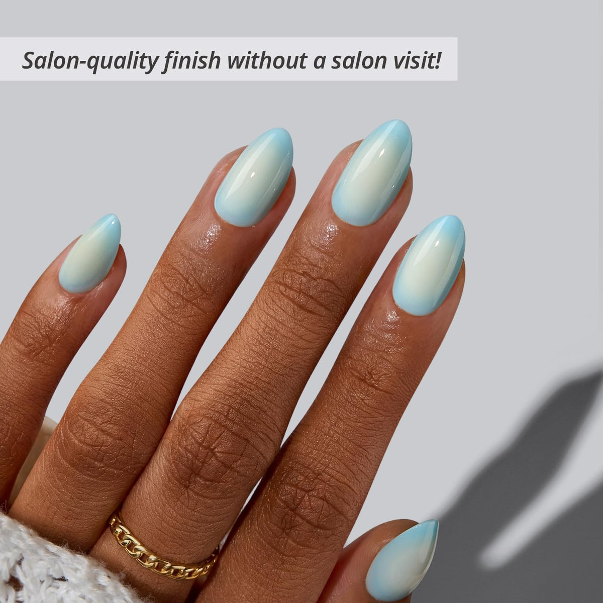 BTArtbox close-up of blue-to-white ombré almond nails highlighting glossy finish