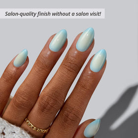 BTArtbox close-up of blue-to-white ombré almond nails highlighting glossy finish
