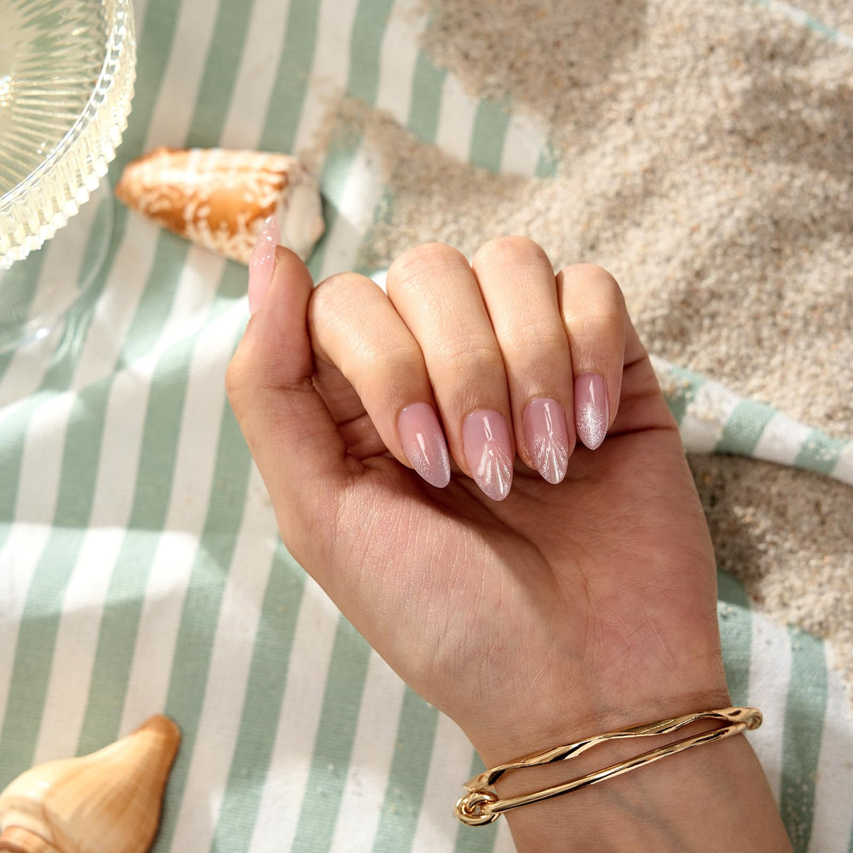 BTArtbox nails held in hand to show size and natural almond scale for true-to-life fit