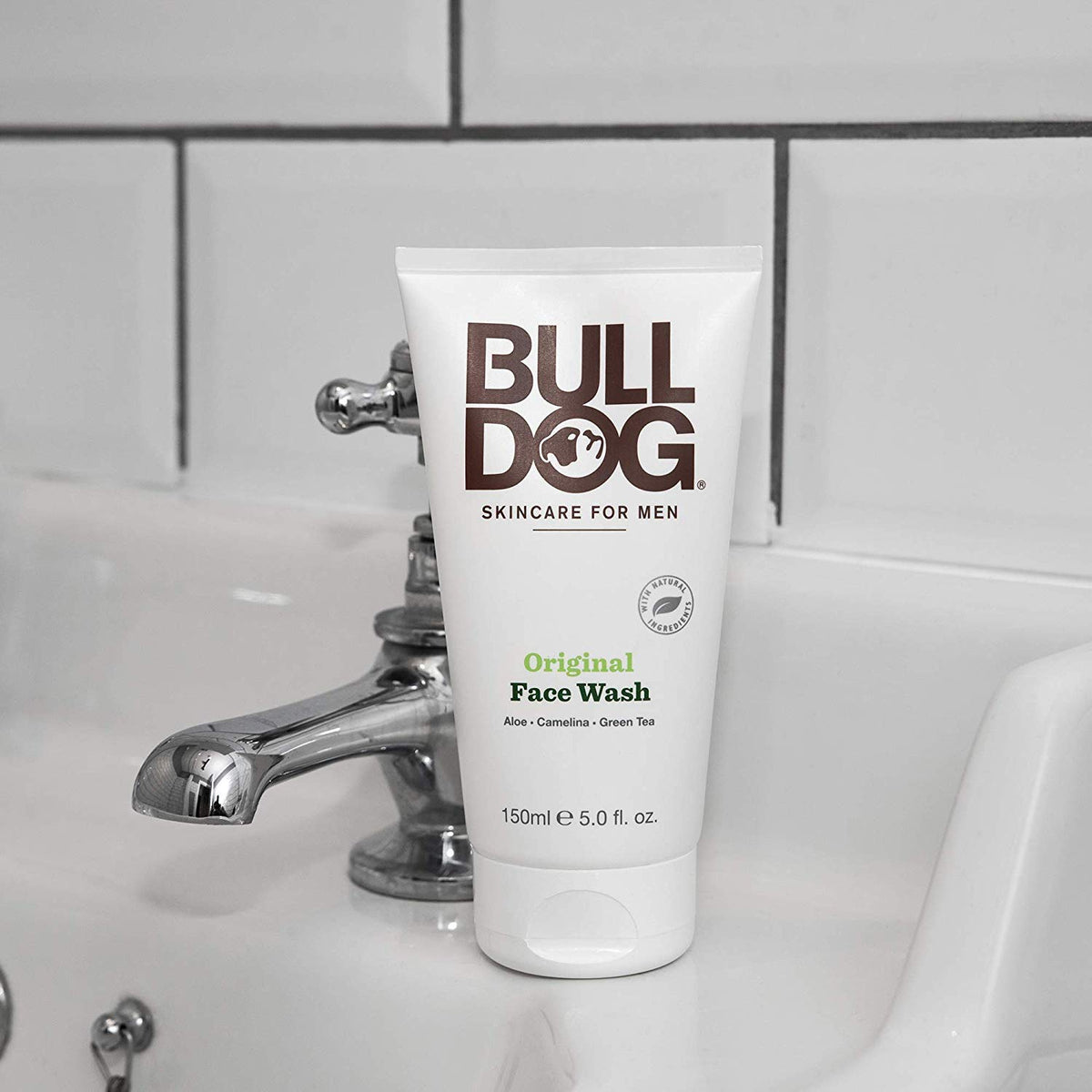 Bulldog tube beside hand for scale showing compact 5 oz size and portability