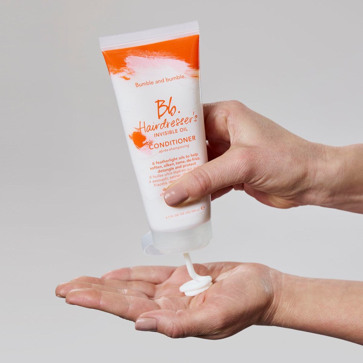 Bumble and bumble label close-up listing oils and color-safe claim
