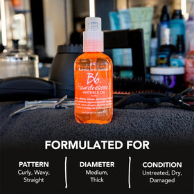 Bumble and bumble bottle beside styling tools demonstrating heat protection use