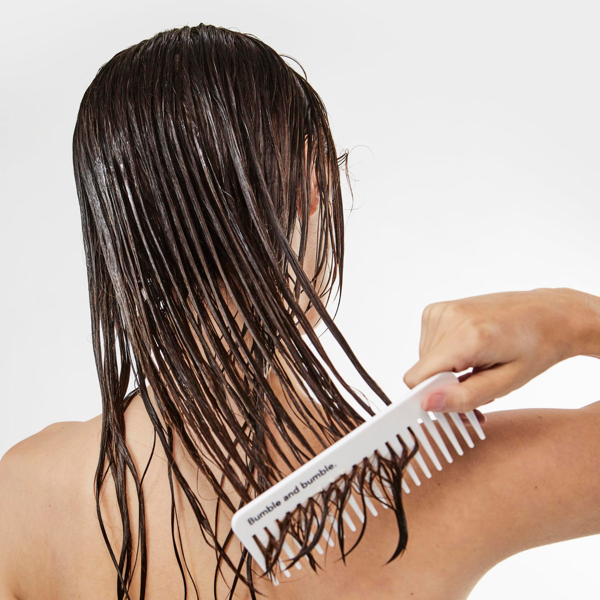 Bumble and bumble rinsing conditioner in shower for plump, fuller-looking strands