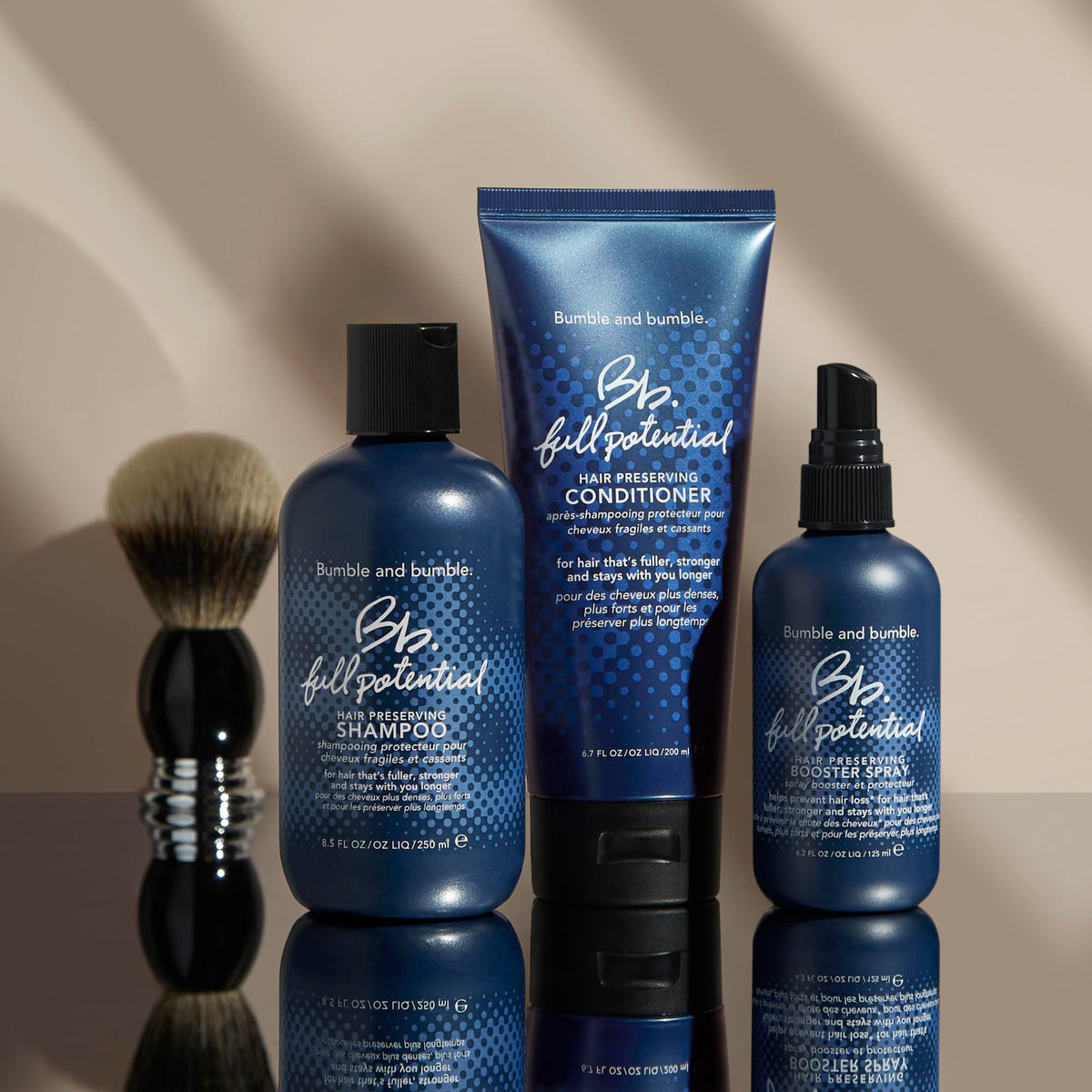 Bumble and bumble bottle next to hand showing 6.7 fl oz size for travel-friendly use