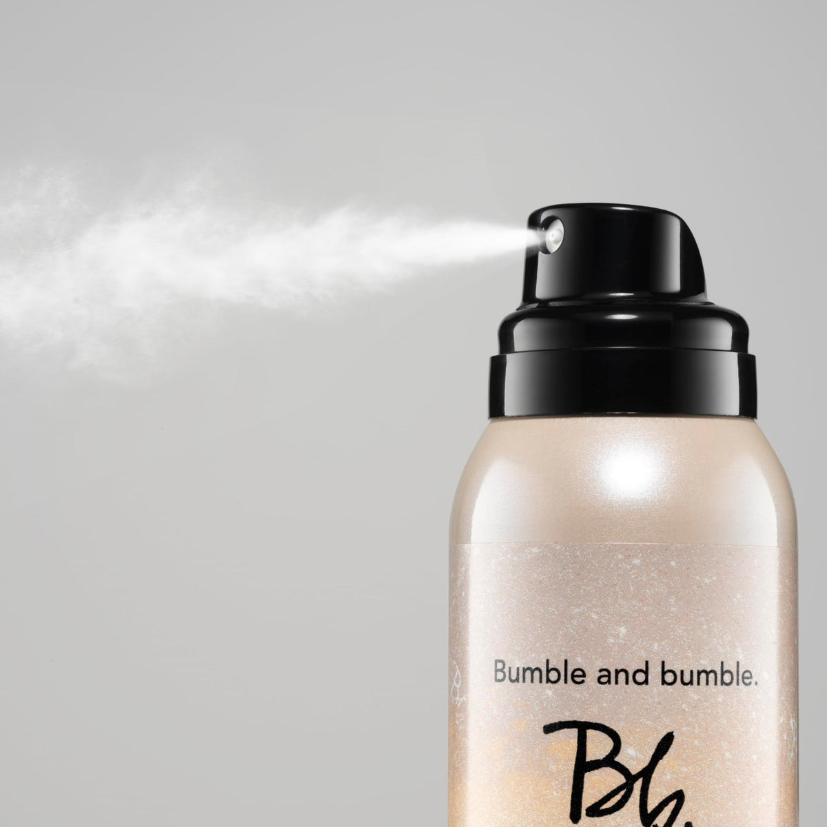 Bumble and bumble open cap with fine powder visible, highlights easy application