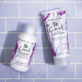 Bumble and bumble applying shampoo to curly hair for improved detangling