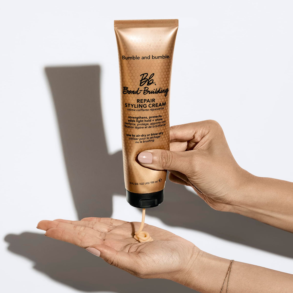 Bumble and bumble size comparison in hand demonstrating travel-friendly 5 fl oz