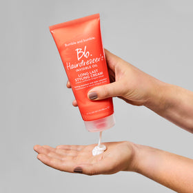 Bumble and bumble. applying cream to damp hair for improved manageability and less frizz