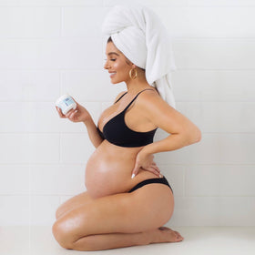 Bumpology being smoothed onto a pregnant belly demonstrating gentle hydration benefits