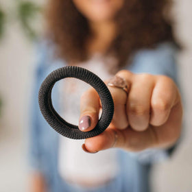 Burlybands wrapped around a thick ponytail demonstrating strong, crease-free hold