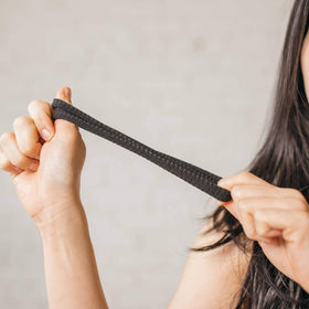 Burlybands next to a coin showing large band size for thick hair comparison