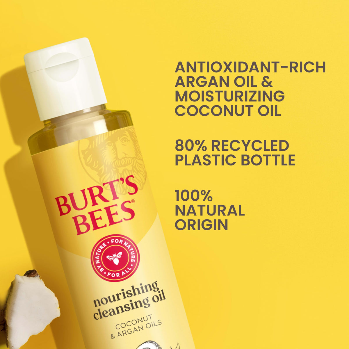 Burt's Bees bottle beside coconut and argan nuts indicating natural oils