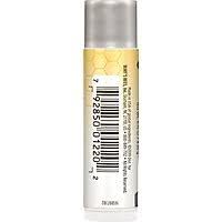 Burt's Bees tucked in purse illustrating on-the-go lip care convenience