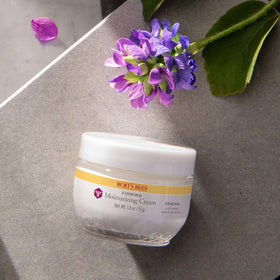 Burt's Bees jar next to a coin to show 1.8 oz size and travel-friendly convenience