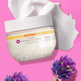 Burt's Bees cream placed with serum and cleanser illustrating layered skincare benefits