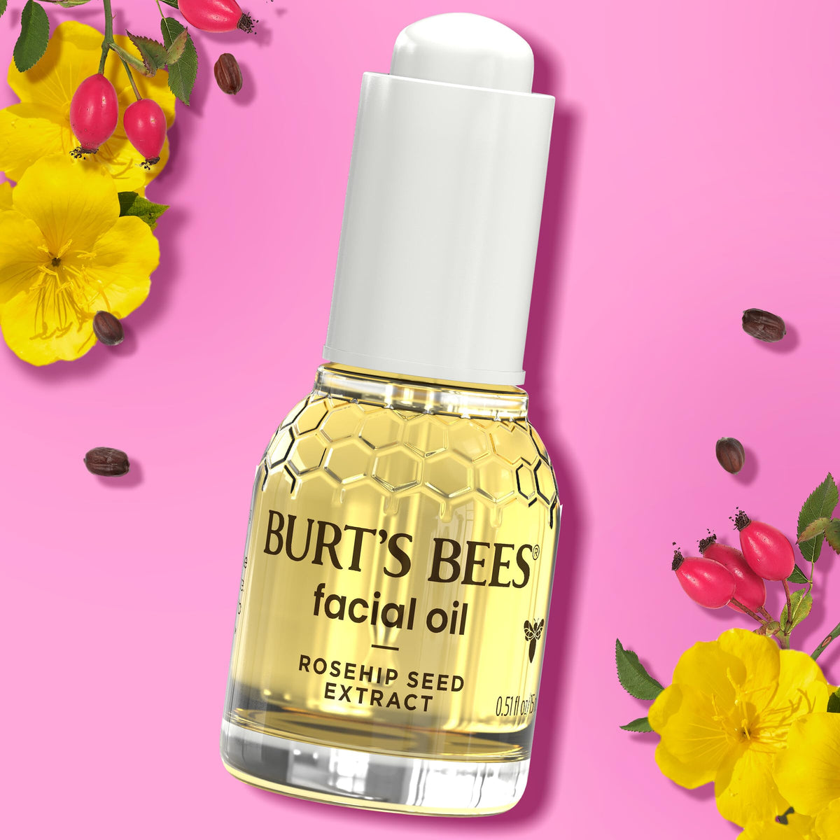 Burt's Bees oil next to a coin for size comparison showing travel-friendly benefit