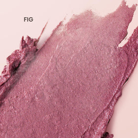 Burt's Bees fig balm swatch on wrist showing buildable rosy shimmer