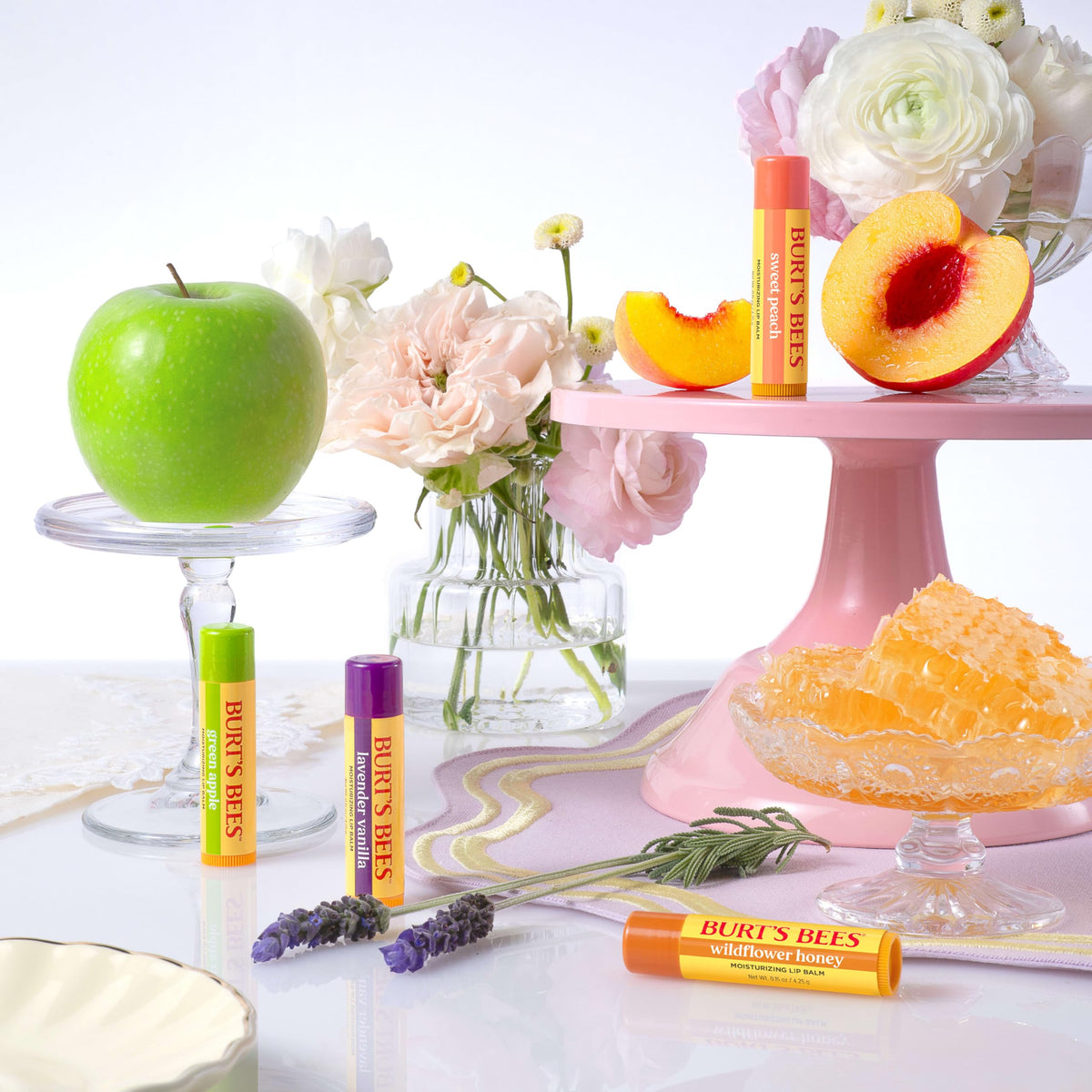 Burt's Bees group of four balms on wooden table showing gift-ready presentation
