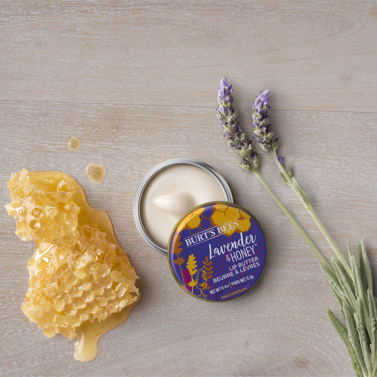 Burt's Bees tin in hand showing size and portability benefits