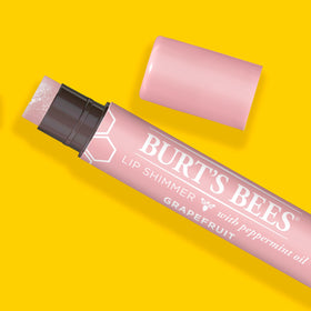 Burt's Bees in a purse pocket showing compact size and on-the-go convenience