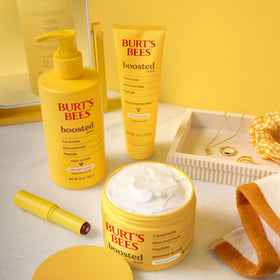 Burt's Bees lotion staged on bathroom shelf suggesting daily routine use