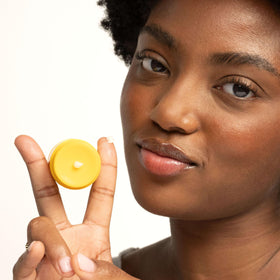 Burt's Bees in a casual pocket lifestyle shot showing on-the-go convenience and freshness benefit