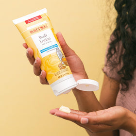 Burt's Bees lotion texture being poured highlighting smooth, fast-absorbing moisture