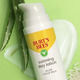 Burt's Bees bottle beside credit card showing compact 1.8 oz size benefit