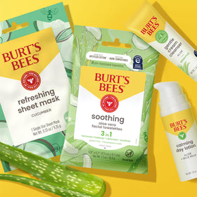 Burt's Bees bottles in hand for size comparison and portable routine clarity
