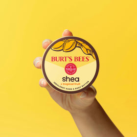 Burt's Bees 11 oz tub held in hand showing true size and portability