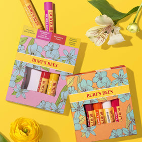 Burt's Bees tube next to a coin for scale showing convenient 0.15 oz travel size
