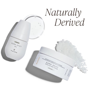 Bushbalm size comparison in hand conveying compact 30 ml oil and 236 ml scrub convenience