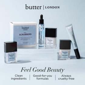 butter LONDON balm next to a coin for scale showing portable, travel-ready size