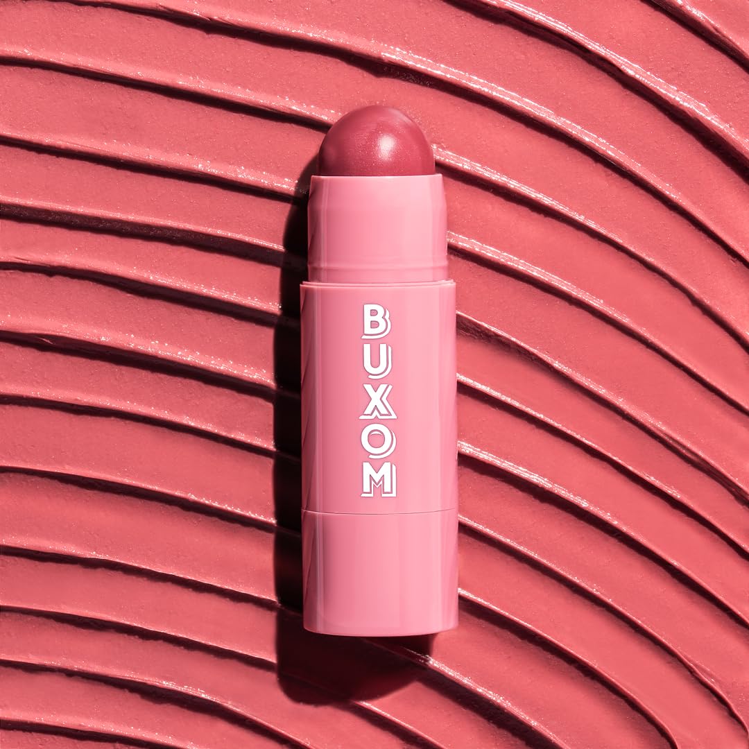 BUXOM Dolly Fever held in hand to show compact size and travel-friendly design