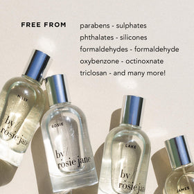 By Rosie Jane bottle beside travel essentials showing compact 8 fl oz convenience