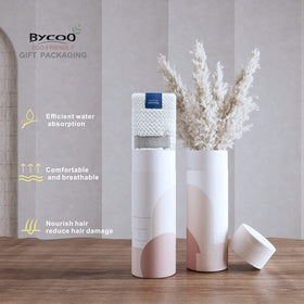 BYCOO towel folded in travel bundle spa setting showing portability benefit