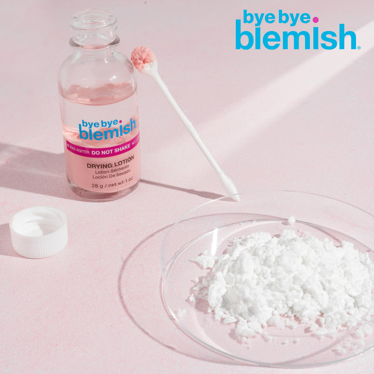Bye Bye Blemish 1oz bottle next to coin to show small travel-friendly size