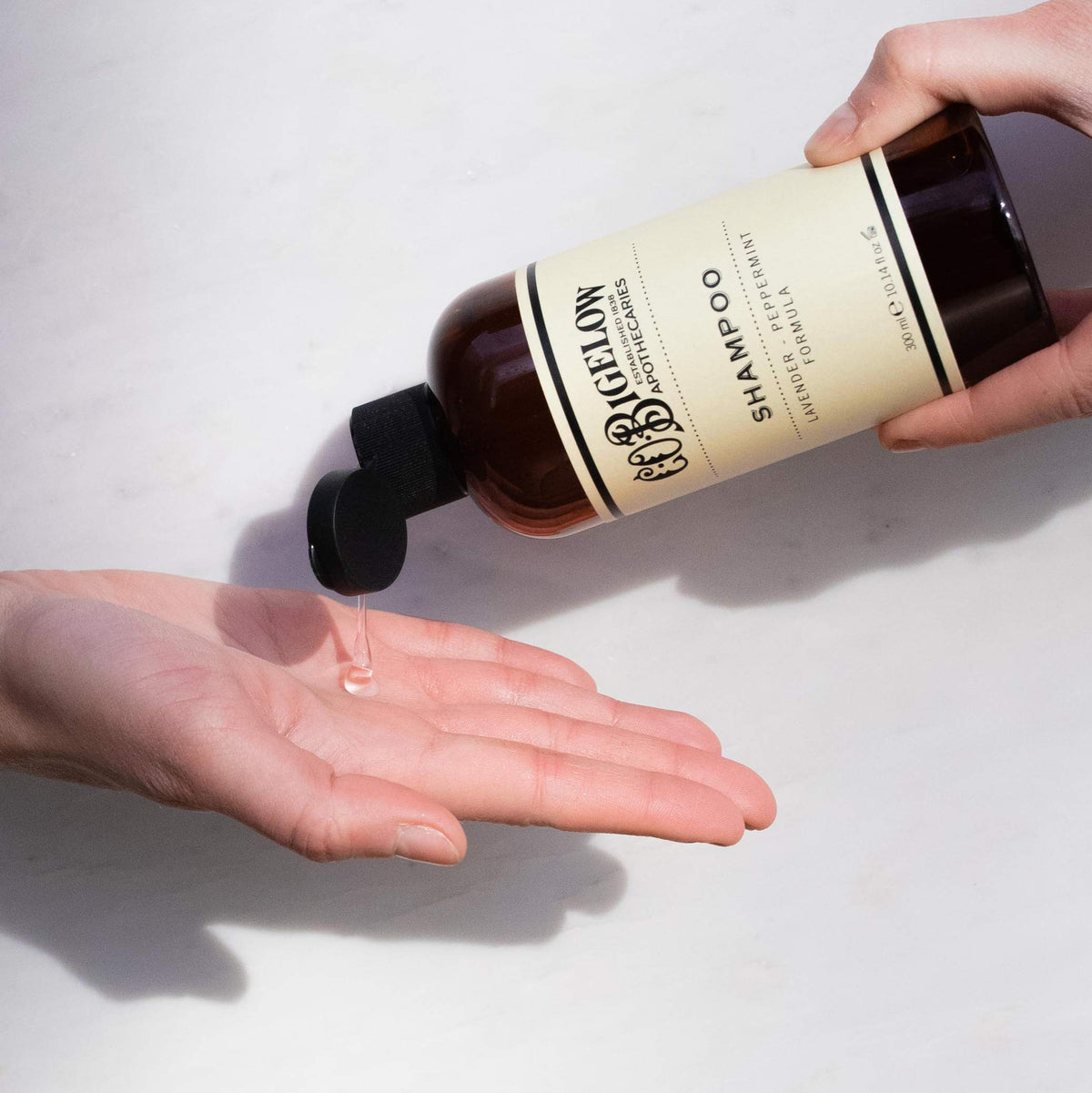 C. O. Bigelow shampoo in shower demonstrating refreshing scalp cleanse benefit