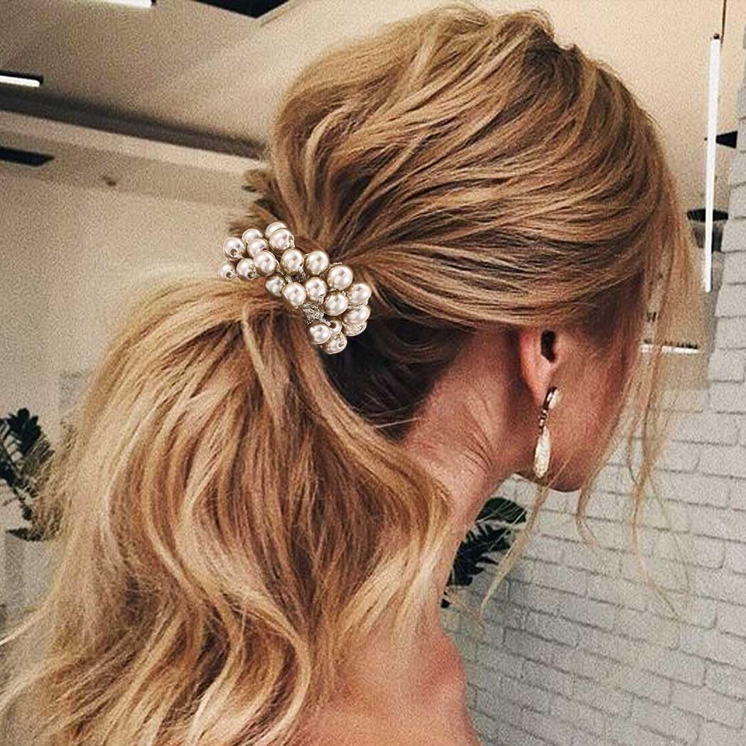 CAKURE in use securing a high ponytail with a decorative pearl finish