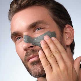 Caldera + Lab applying mask from hand to face demonstrating easy use