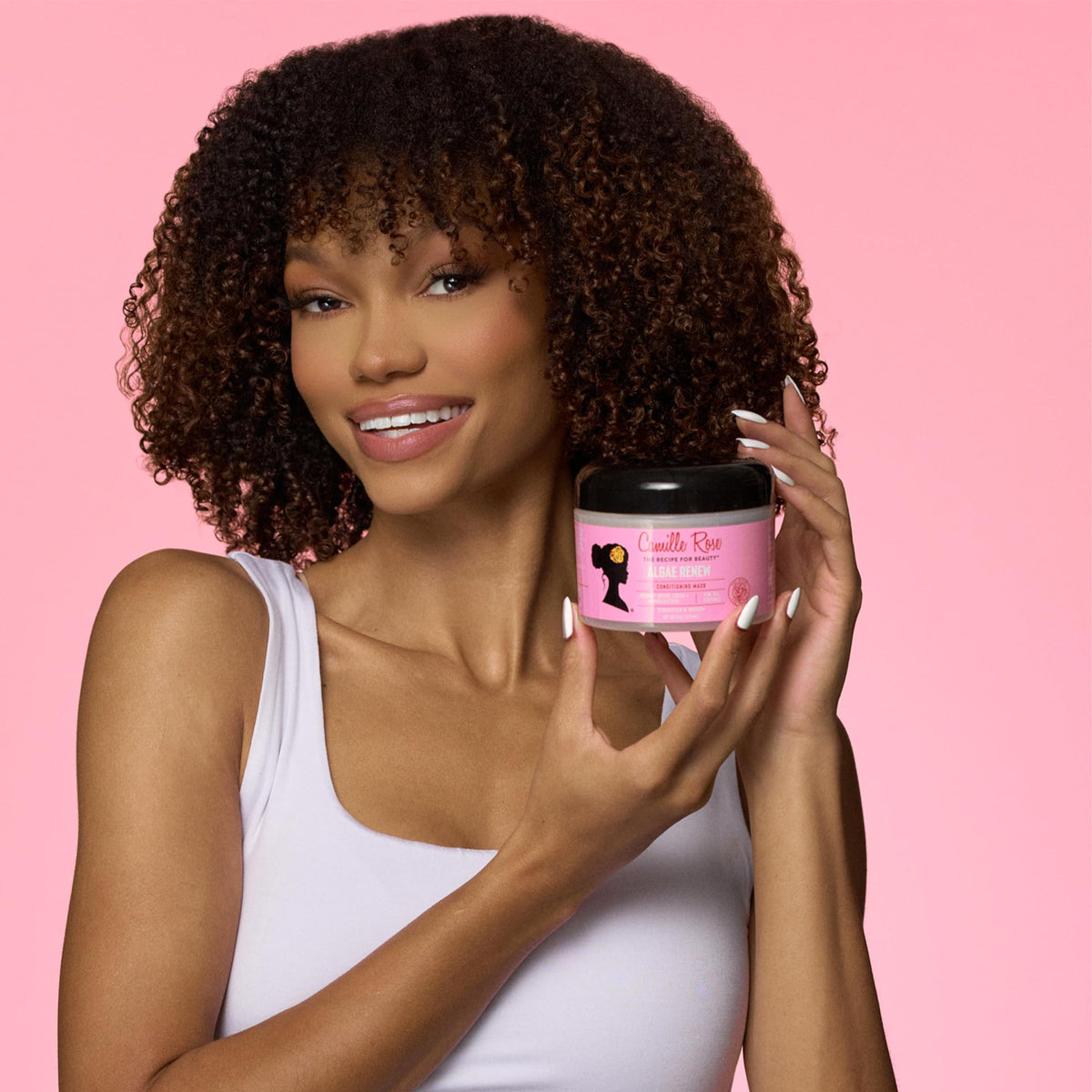 Camille Rose applied on textured hair during treatment showing smooth results