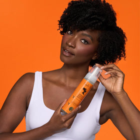 Camille Rose in-use scrunching curly hair to show definition and frizz control