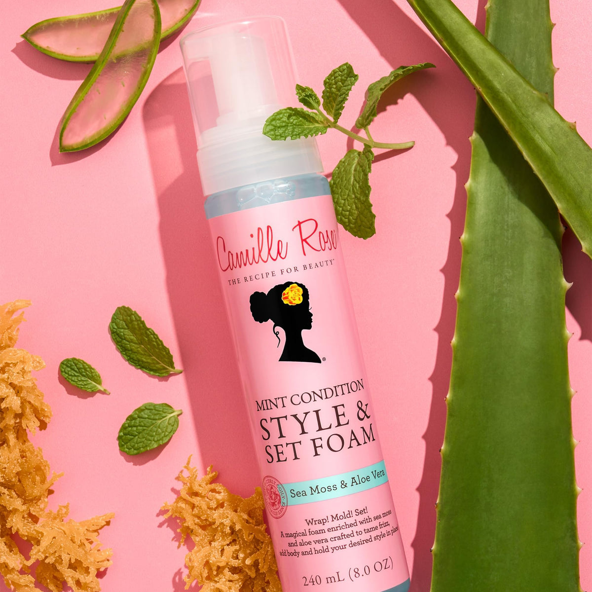 Applying Camille Rose foam to damp hair demonstrating even distribution and lightweight hold