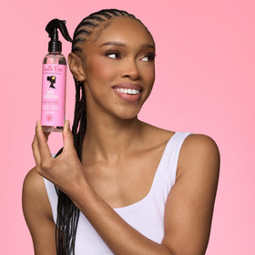 Camille Rose being applied to braids to soothe scalp and refresh styles