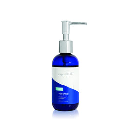 Capri Blue front bottle showing cobalt pump and Volcano scent benefits