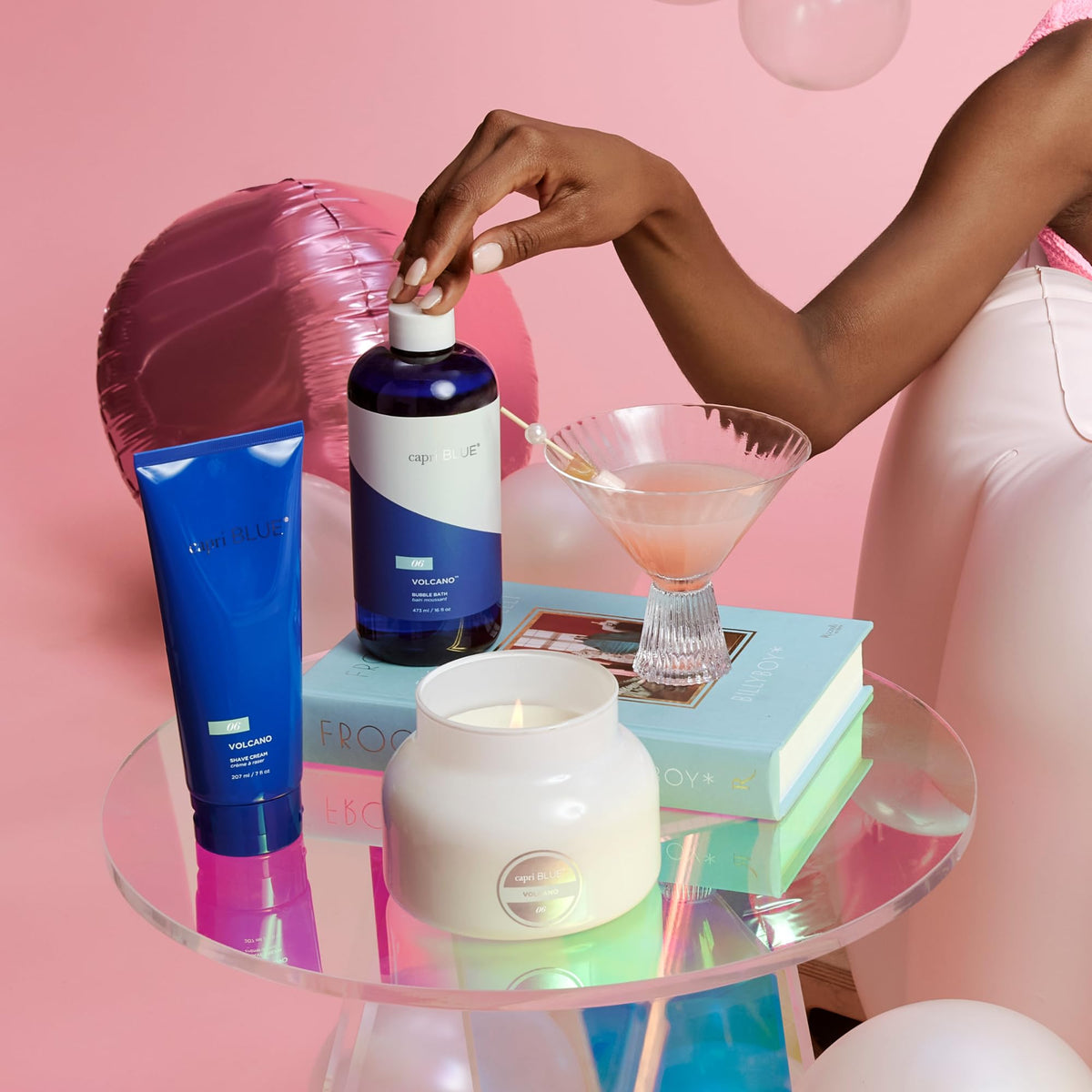 Watermelon and pomegranate near Capri Blue bottle highlighting natural extracts benefit