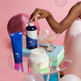 Watermelon and pomegranate near Capri Blue bottle highlighting natural extracts benefit