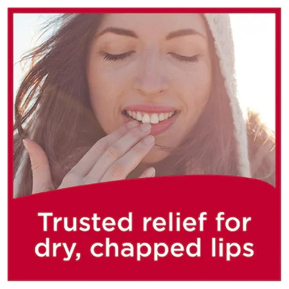 Carmex Fresh Cherry tube on a beach towel illustrating water-resistant outdoor benefit