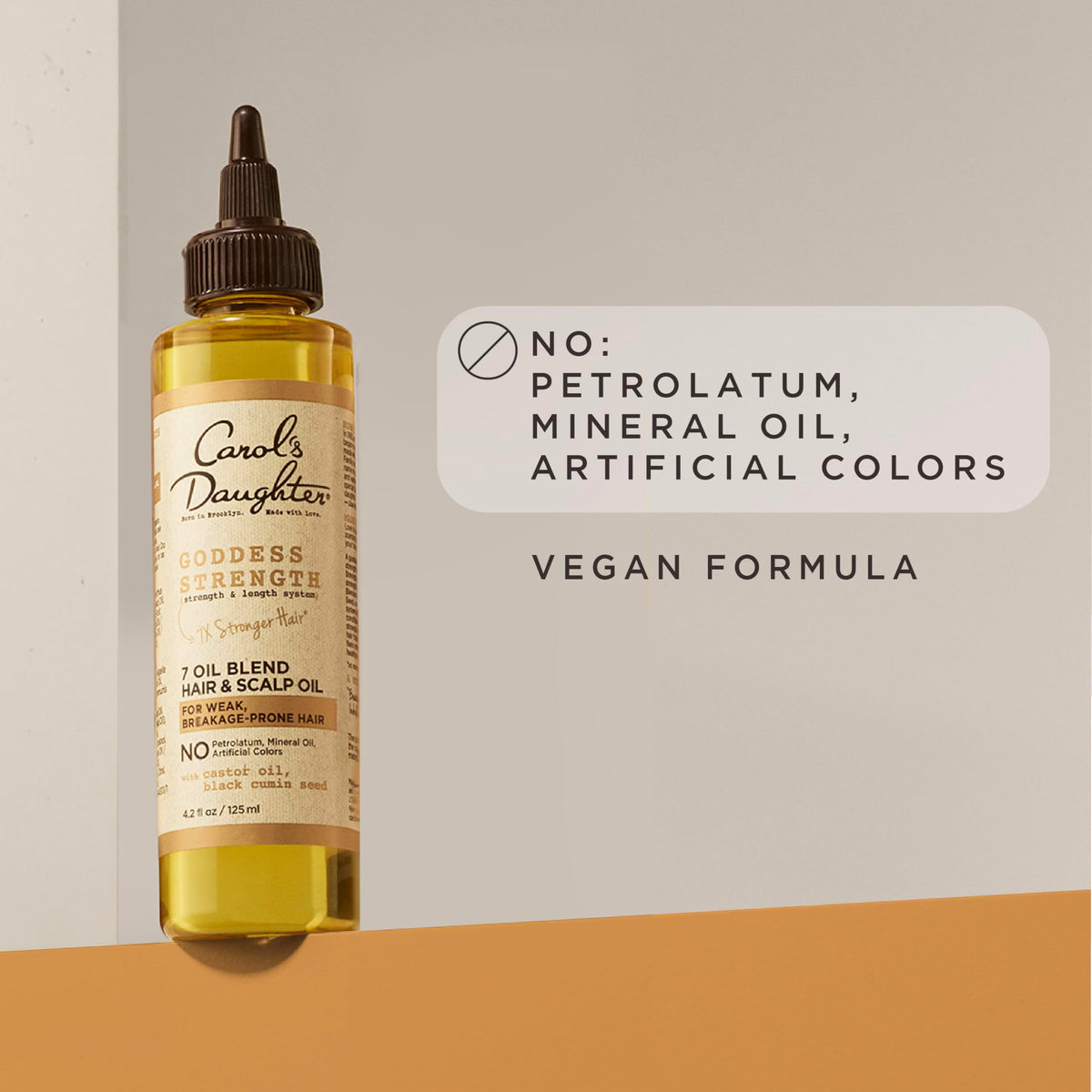 Carol's Daughter label close-up highlighting castor and botanical oil blend